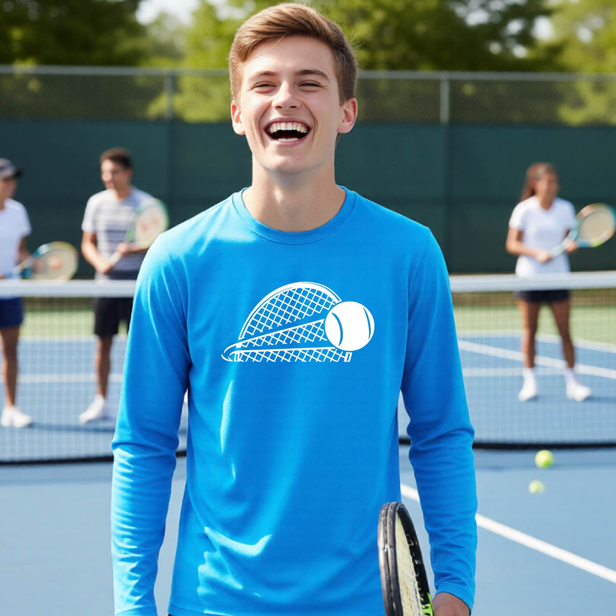 A young person on a blue tennis court holds a tennis racket and wears a bright blue long-sleeve T-shirt with a white graphic of a half a tennis racquet with a ball streaking over it. 