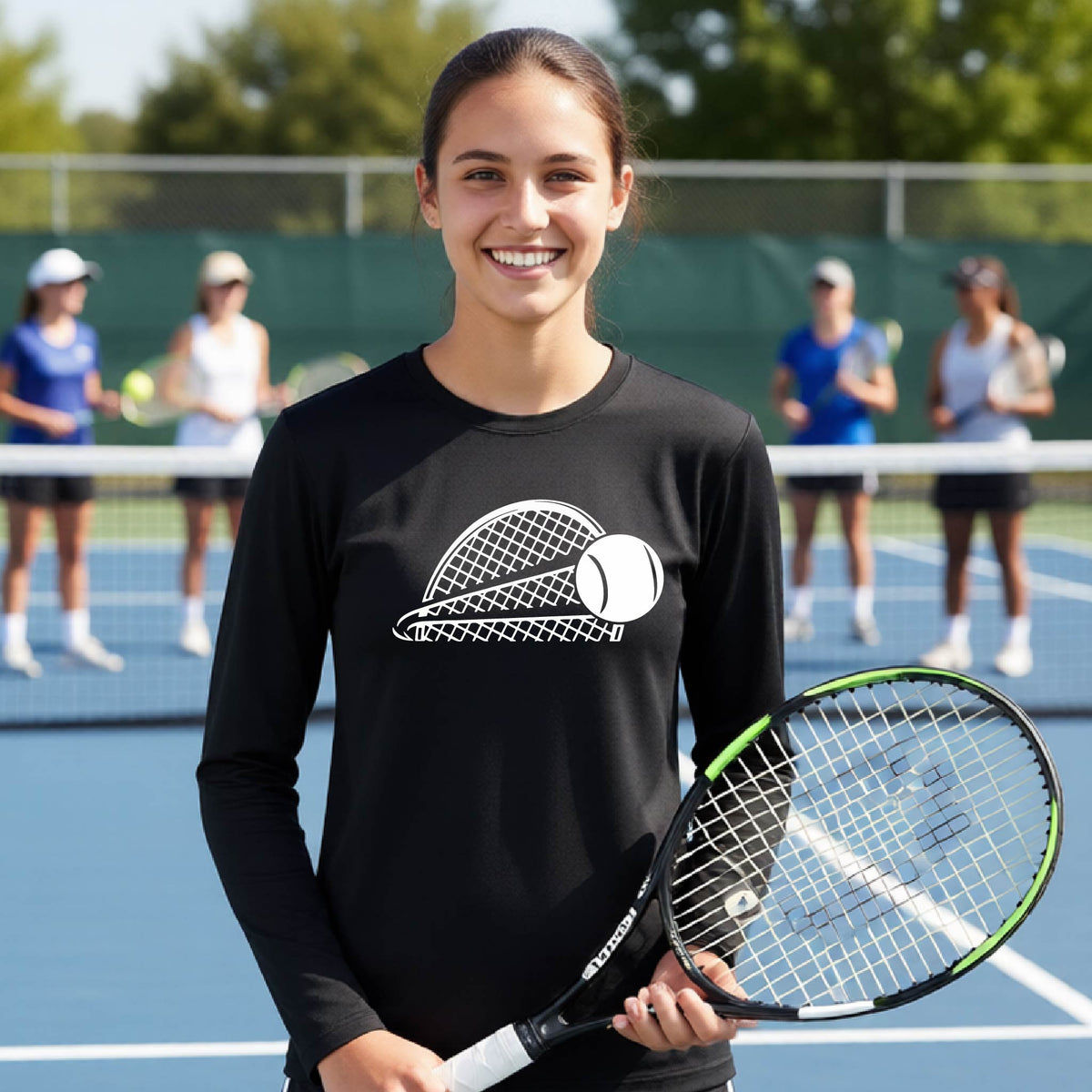 A young person on a blue tennis court holds a tennis racket and wears a black long-sleeve T-shirt with a white graphic of a half a tennis racquet with a ball streaking over it. 