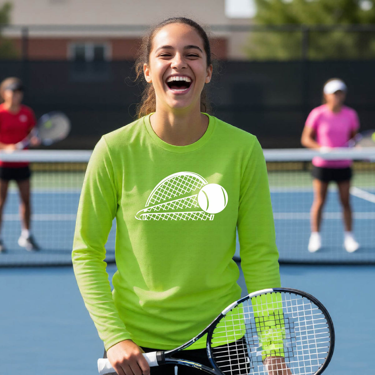 A young person on a blue tennis court holds a tennis racket and wears a lime green long-sleeve T-shirt with a white graphic of a half a tennis racquet with a ball streaking over it. 