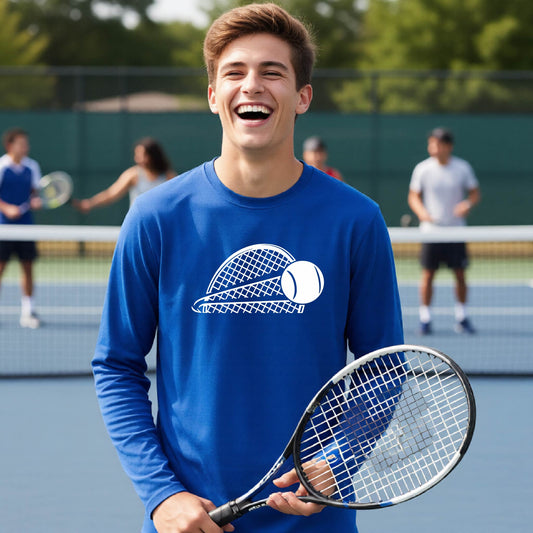 A young person on a blue tennis court holds a tennis racket and wears a royal blue long-sleeve T-shirt with a white graphic of a half a tennis racquet with a ball streaking over it. 
