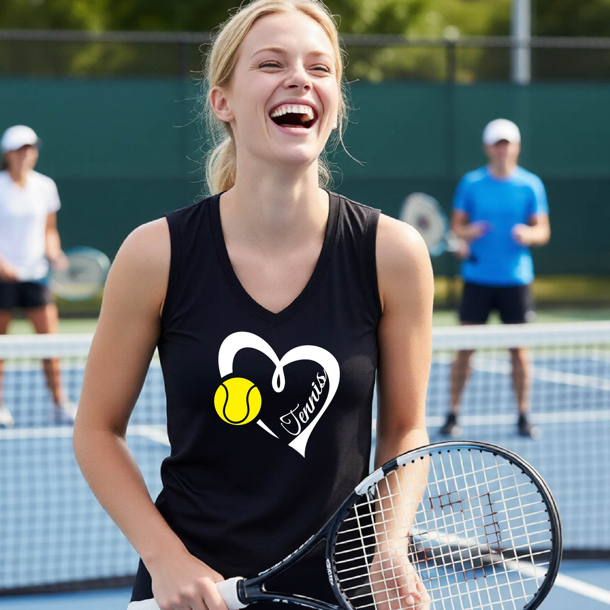 A woman laughing on a tennis court wearing a black tank top with a white heart outline, a yellow tennis ball graphic, and the word 'Tennis' printed on the front. She is holding a tennis racket, with other players blurred in the background.