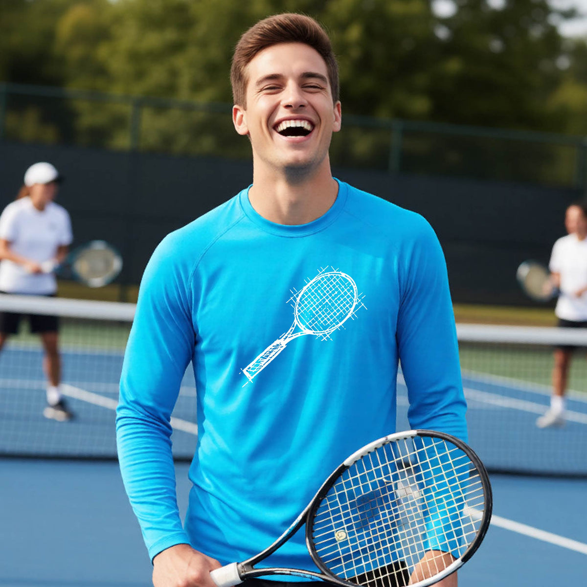 A man on a blue tennis court holds a tennis racket and wears a bright blue long-sleeve T-shirt with a white retro tennis racquet graphic.  