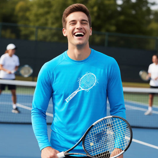 A man on a blue tennis court holds a tennis racket and wears a bright blue long-sleeve T-shirt with a white retro tennis racquet graphic.  