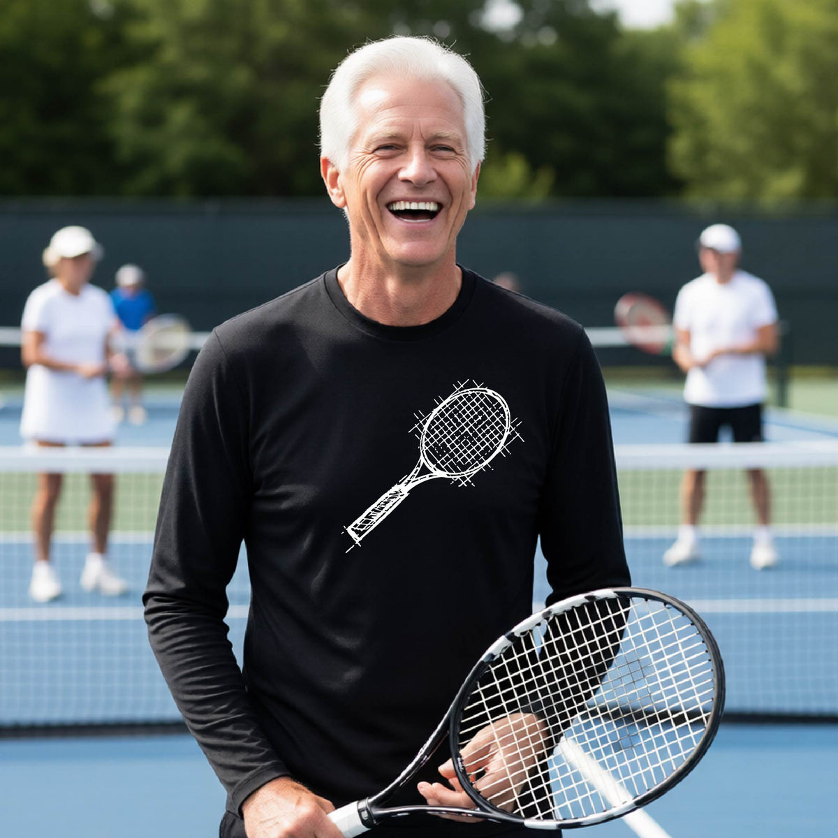 A man on a blue tennis court holds a tennis racket and wears a black long-sleeve T-shirt with a white retro tennis racquet graphic.  