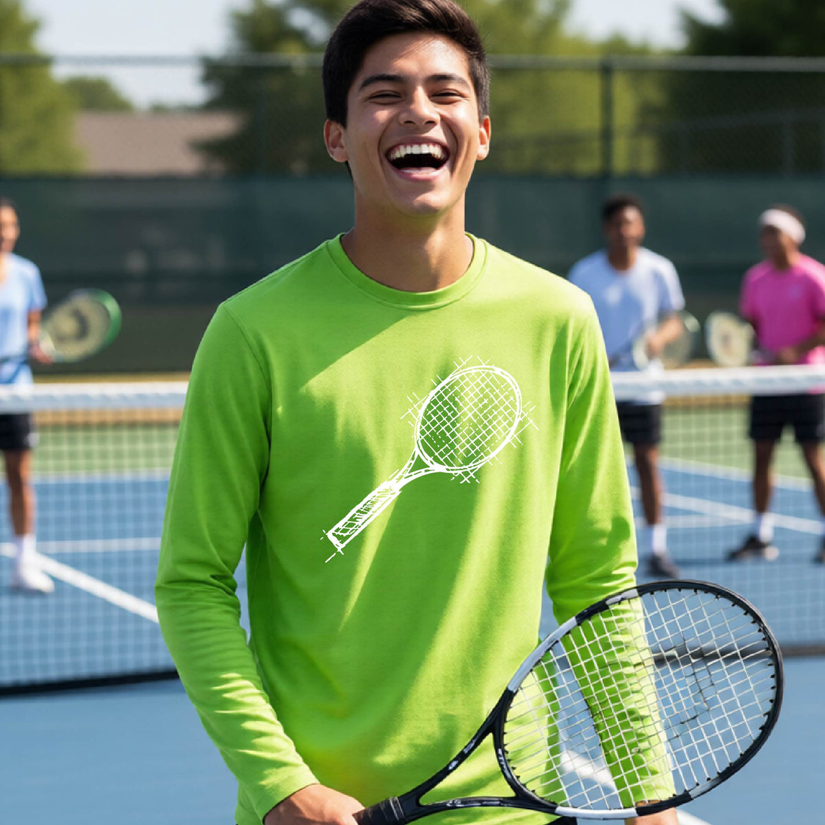 A young person on a blue tennis court holds a tennis racket and wears a lime green long-sleeve T-shirt with a white retro tennis racquet graphic.  