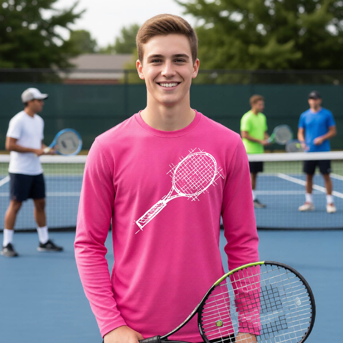 A young person on a blue tennis court holds a tennis racket and wears a pink long-sleeve T-shirt with a white retro tennis racquet graphic.  