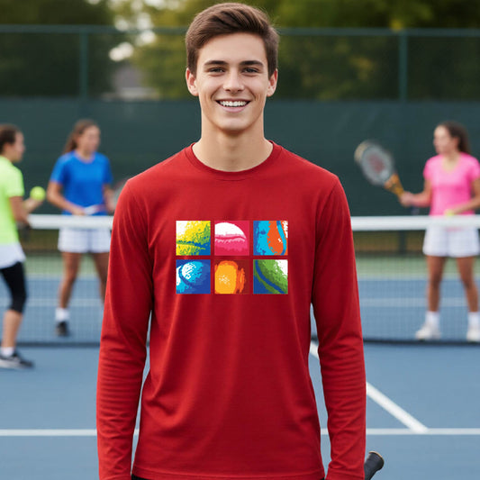 A smiling young man stands on a tennis court wearing a red long-sleeve shirt with a colorful 2x3 graphic print on the chest. Other tennis players are blurred in the background.