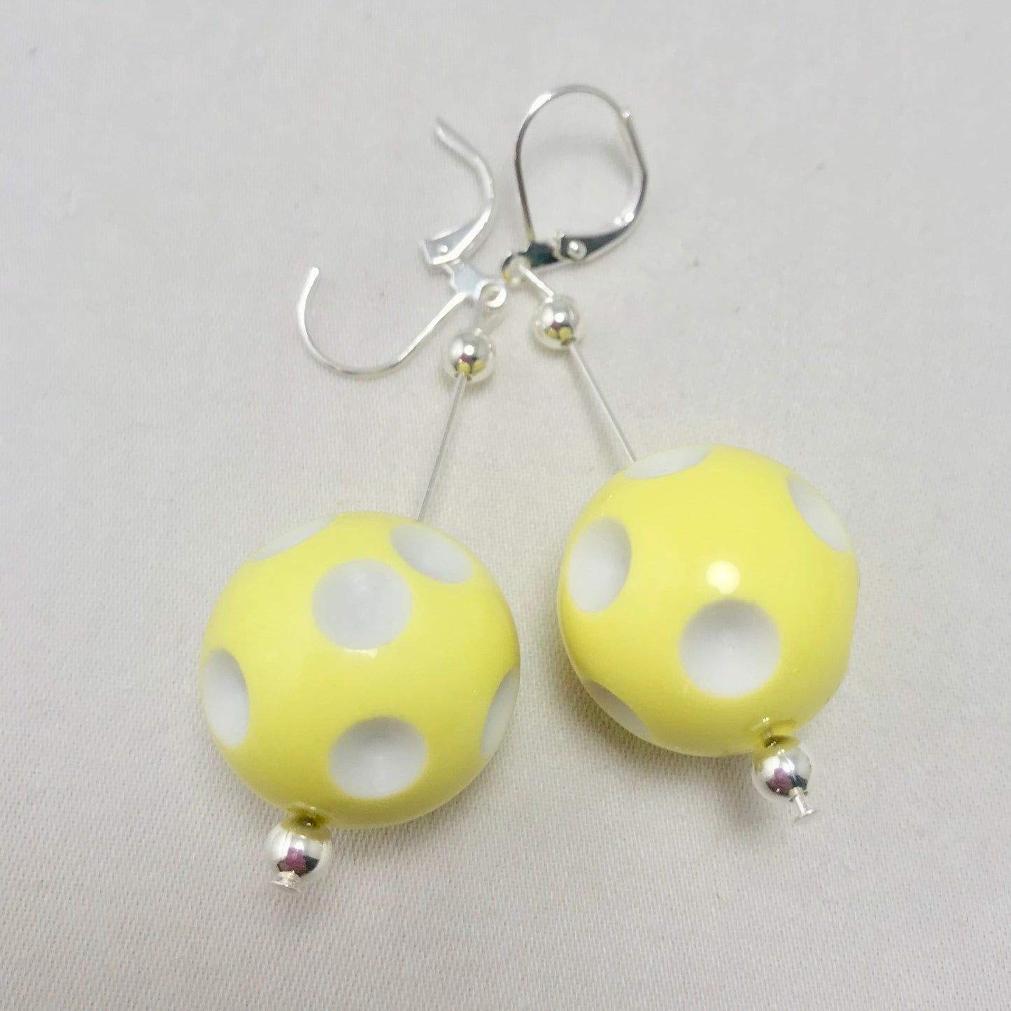 Mini Pickleball Dangling Earrings - Eight Colors to Choose From  Super cute pickleball beads made into dangle earrings. They hang approximately an 2 and a half inches down. The beads are approximately 1/2 an inch in width.  Show your love for pickleball wherever you go with these super sweet earrings. Colors to match any outfit!! 