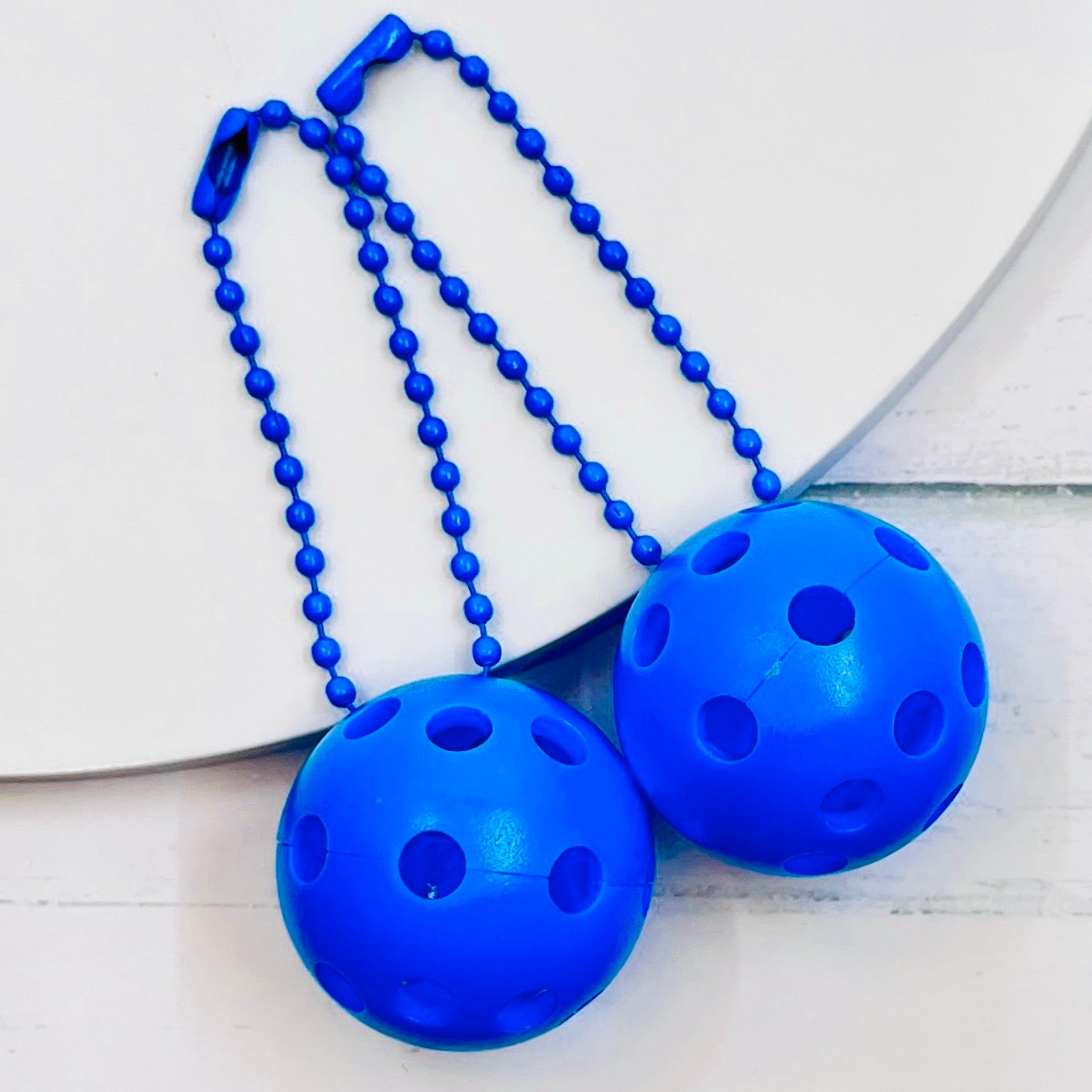 Micro Pickleball Bag Tags/Pulls (Set of 2)  Each order gets you 2 of the cutest little pickleball and chain! They measure about 1 inch and are used as bag tag markers. Fun for any bag, especially your pickleball bag!! The balls come in 4 colors: Red, Green, Blue, and Yellow. They now also come with matching chain colors!! Choose from 4 fun colors.