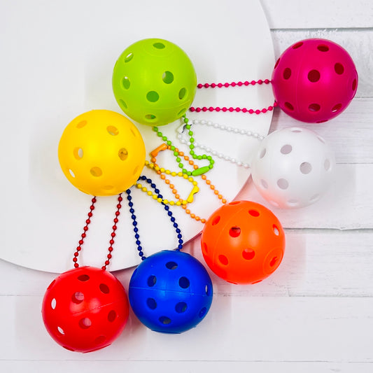 Mini Pickleball Bag Tags/Pulls (Set of 2)  Each order gets you 2 of the little mini pickleballs and chain! They measure about 1 1/2 inches and are used as bag tag markers. Fun for any bag, especially your pickleball bag!! The balls come in 7 colors: Red, Green, Blue, Orange, White, Pink, and Yellow. Choose 2 of the 7 fun colors.