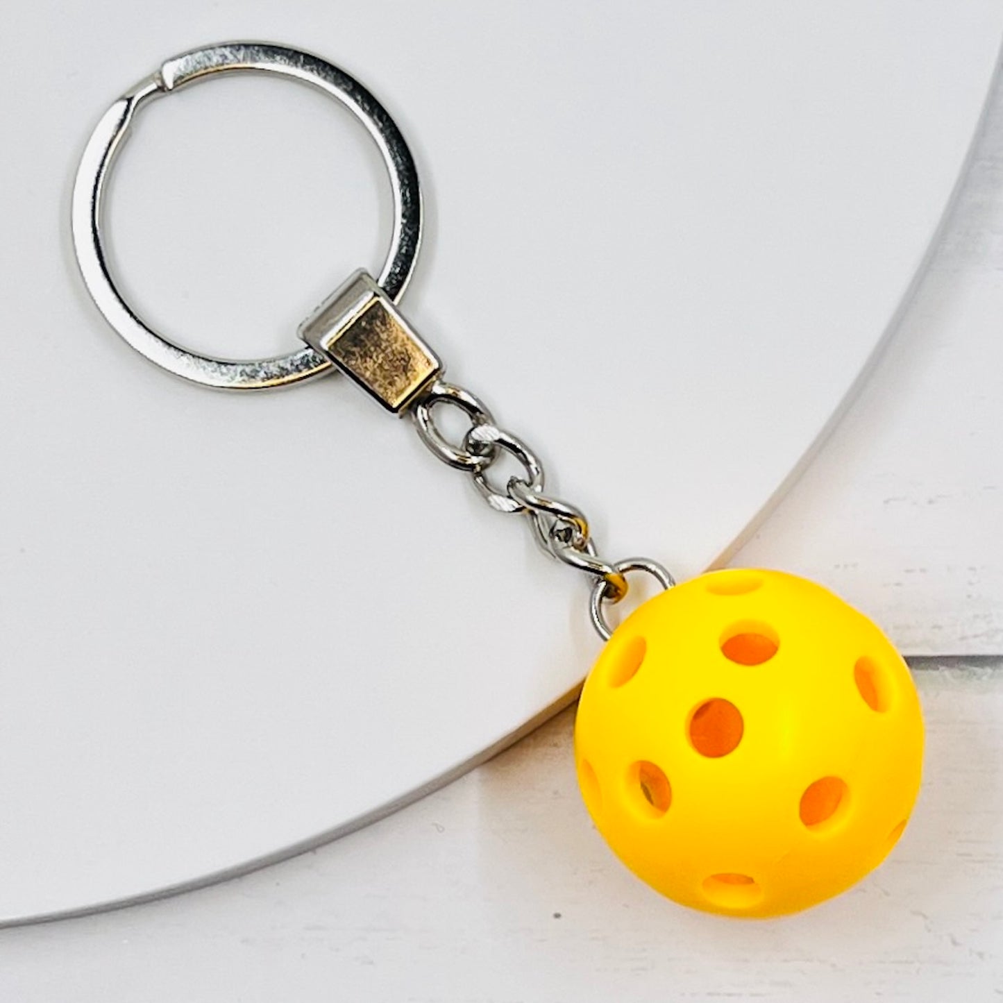Heavy Duty Micro Pickleball Bags Tags/Pulls  Each order gets you 1 of the cutest little pickleball and heavy duty chains! The micro pickleballs measure about 1 inch and are used as bag tag markers. Fun for any bag, especially your pickleball bag!! The balls come in 4 colors: Red, Green, Blue, and Yellow. Choose from 4 fun colors.