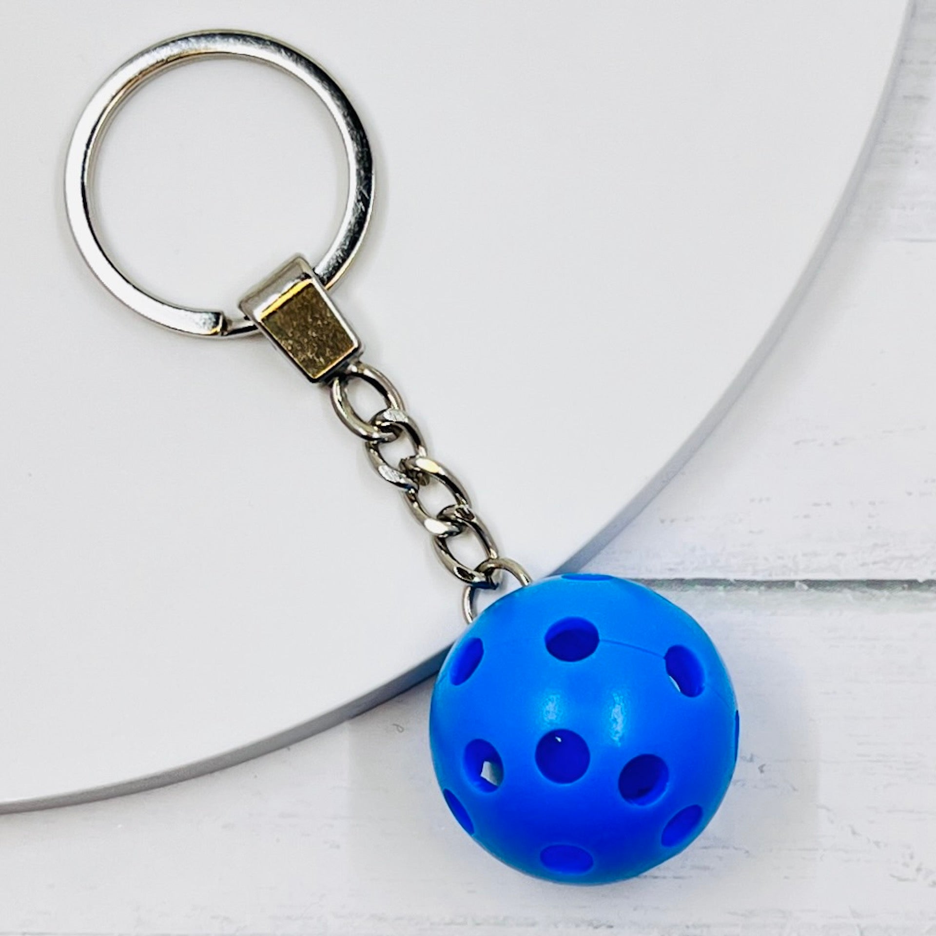 Heavy Duty Micro Pickleball Bags Tags/Pulls  Each order gets you 1 of the cutest little pickleball and heavy duty chains! The micro pickleballs measure about 1 inch and are used as bag tag markers. Fun for any bag, especially your pickleball bag!! The balls come in 4 colors: Red, Green, Blue, and Yellow. Choose from 4 fun colors.