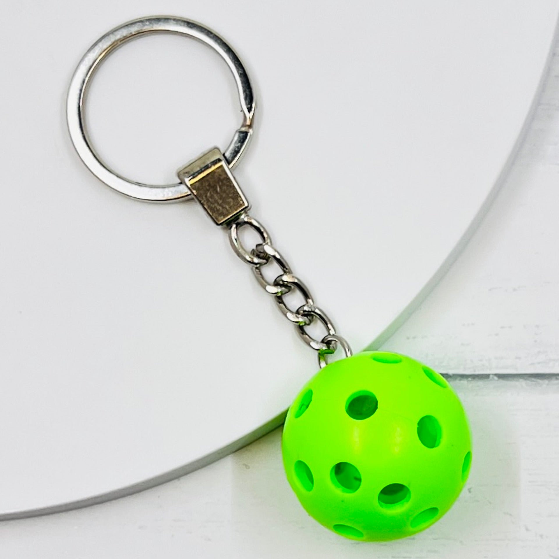 Heavy Duty Micro Pickleball Bags Tags/Pulls  Each order gets you 1 of the cutest little pickleball and heavy duty chains! The micro pickleballs measure about 1 inch and are used as bag tag markers. Fun for any bag, especially your pickleball bag!! The balls come in 4 colors: Red, Green, Blue, and Yellow. Choose from 4 fun colors.