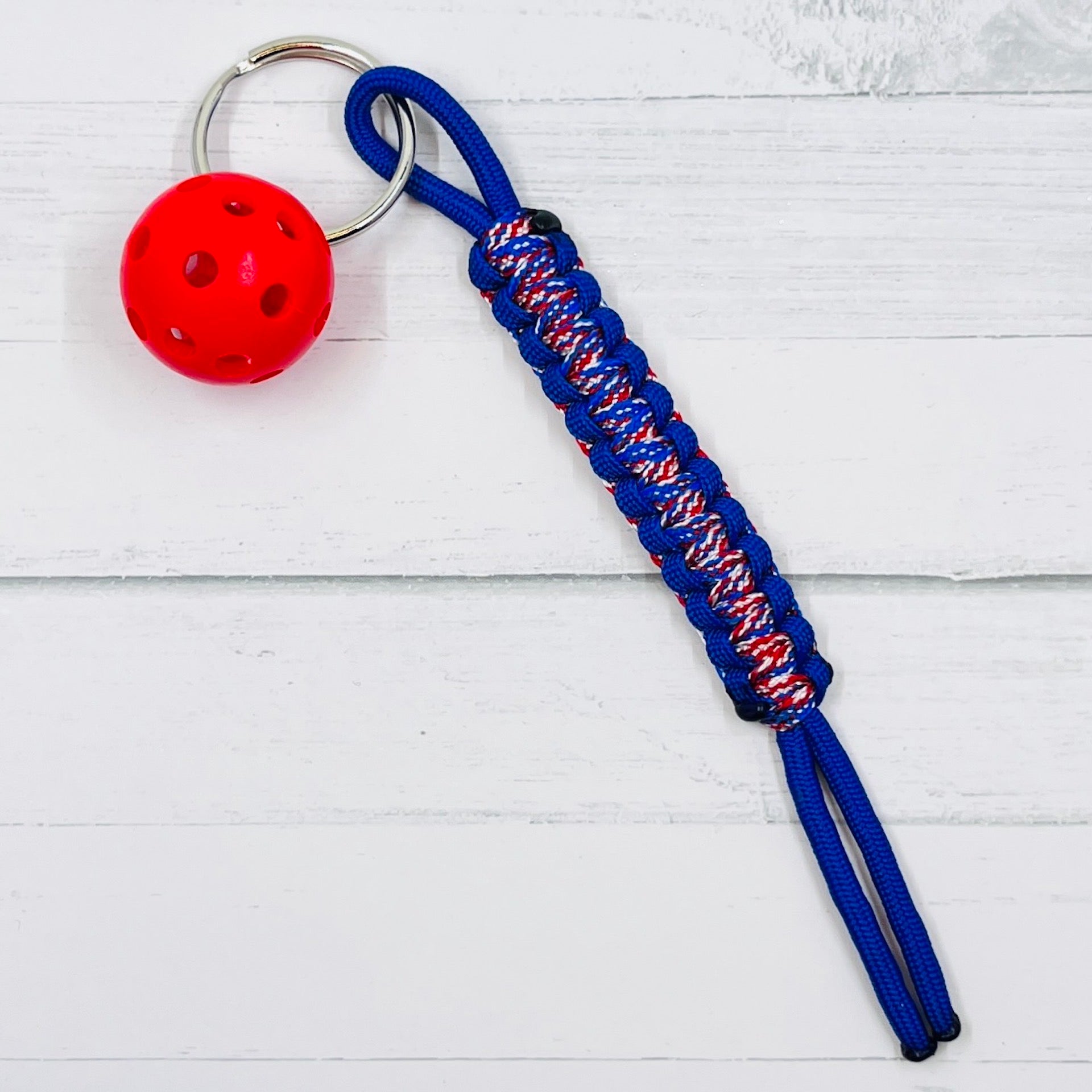 Micro Pickleball Keychain with Pull Tag Lanyard  This keychains are one-a-kind. They are super heavy duty and guaranteed to become your favorite keychain ever. There are multiple colors to choose from (and custom requests are available when possible). You also get to choose the color of ball you would like.  These keychains make it is so much easier to find your keys, especially in a purse. They are easy to carry also.