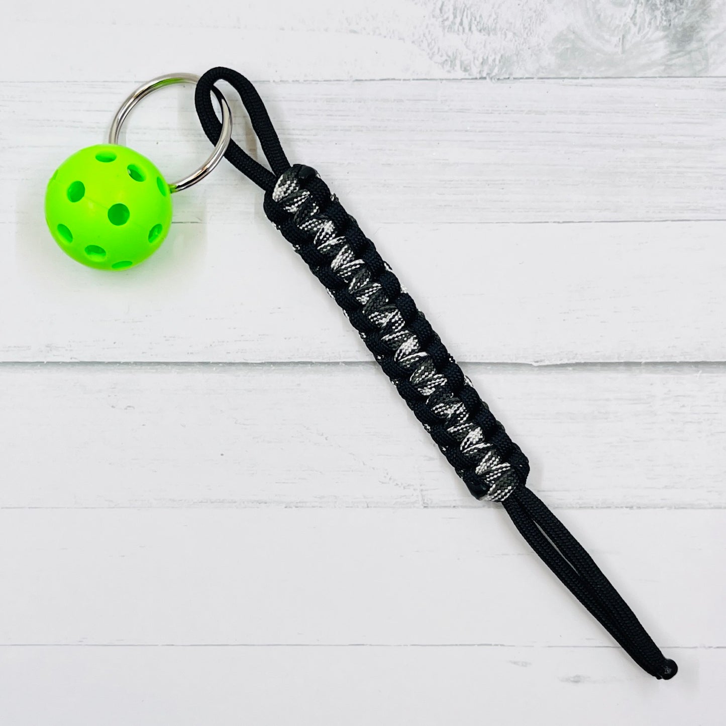 Micro Pickleball Keychain with Pull Tag Lanyard  This keychains are one-a-kind. They are super heavy duty and guaranteed to become your favorite keychain ever. There are multiple colors to choose from (and custom requests are available when possible). You also get to choose the color of ball you would like.  These keychains make it is so much easier to find your keys, especially in a purse. They are easy to carry also.