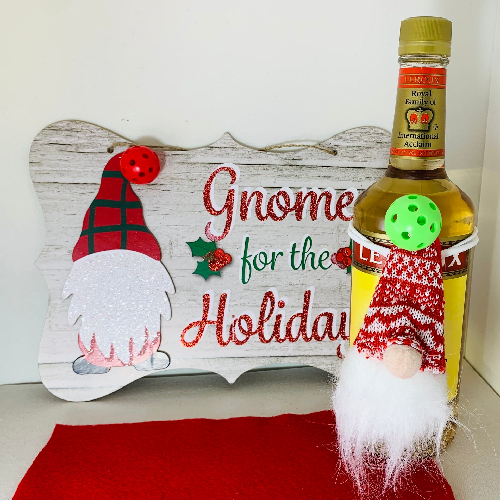 PICKLEBALL GNOME WINE BOTTLE TOPPER-HOUSEWARMING GIFT Make a statement this Christmas by giving a gift wrapped in Style. You will make an entrance at your next holiday pickleball gathering with this cute pickleball wine topper. Your wine and spirits gifts for friends and loved ones will be extra-special with these darling Pickleball Gnome toppers!
