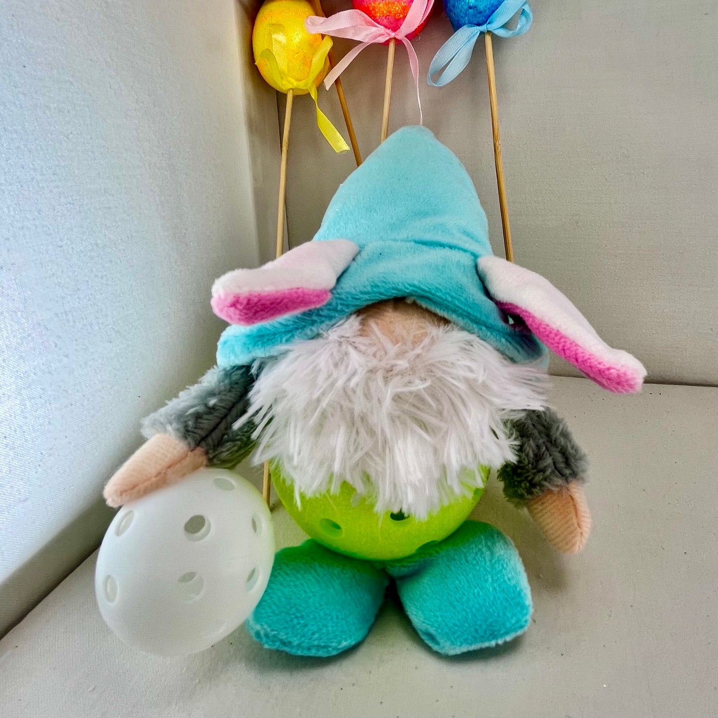 Upcycled Pickleball Easter bunny gnomes for the Easter Holiday.  Decoration or gift set.  These pint-sized pickleball gnomes are perfect for decoration or gifts for your pickleball addicted friends. Each Pickleball Gnome's body is an upcycled full-sized pickleball with a cute little egg in their hands.