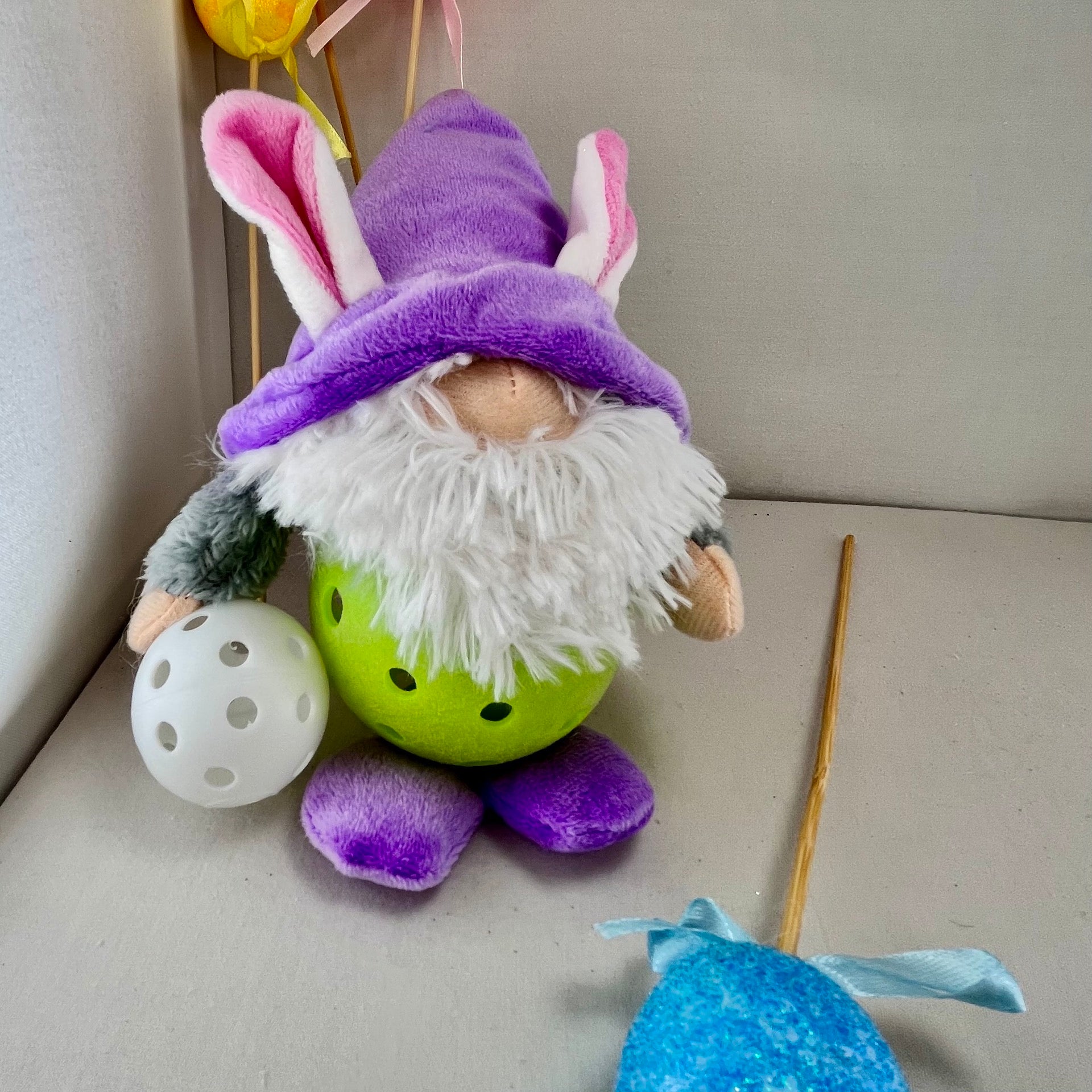 Upcycled Pickleball Easter bunny gnomes for the Easter Holiday.  Decoration or gift set.  These pint-sized pickleball gnomes are perfect for decoration or gifts for your pickleball addicted friends. Each Pickleball Gnome's body is an upcycled full-sized pickleball with a cute little egg in their hands.