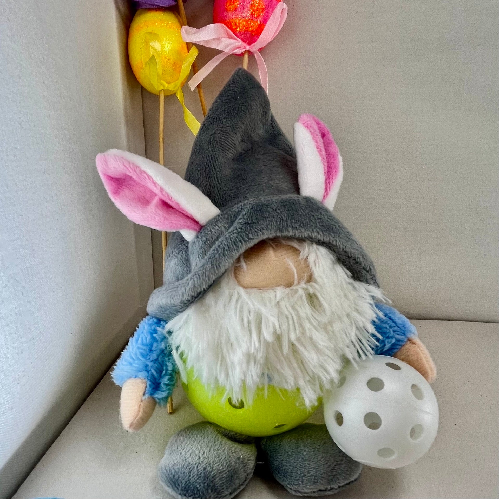 Upcycled Pickleball Easter bunny gnomes for the Easter Holiday.  Decoration or gift set.  These pint-sized pickleball gnomes are perfect for decoration or gifts for your pickleball addicted friends. Each Pickleball Gnome's body is an upcycled full-sized pickleball with a cute little egg in their hands.