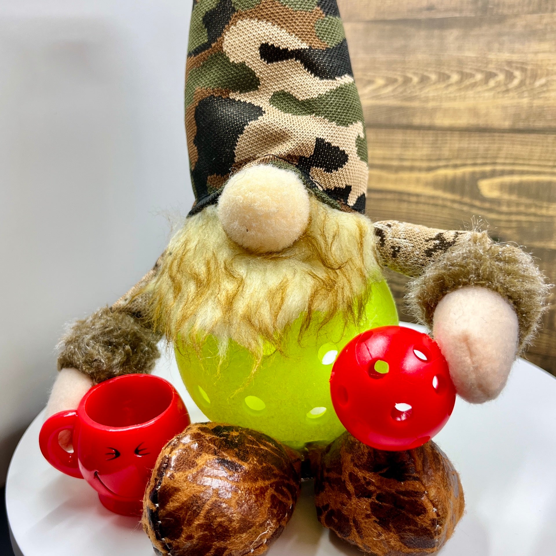 LARGE CAMO & COFFEE PICKLEBALL GNOME DECORATION AND GIFT!!  These large-sized pickleball gnomes are perfect for decoration or gifts for your pickleball addicted friends. Each Gnome is free-sitting and has a coffee cup for enjoyment. Adding a Pickleball Gnome to your house only makes it better.