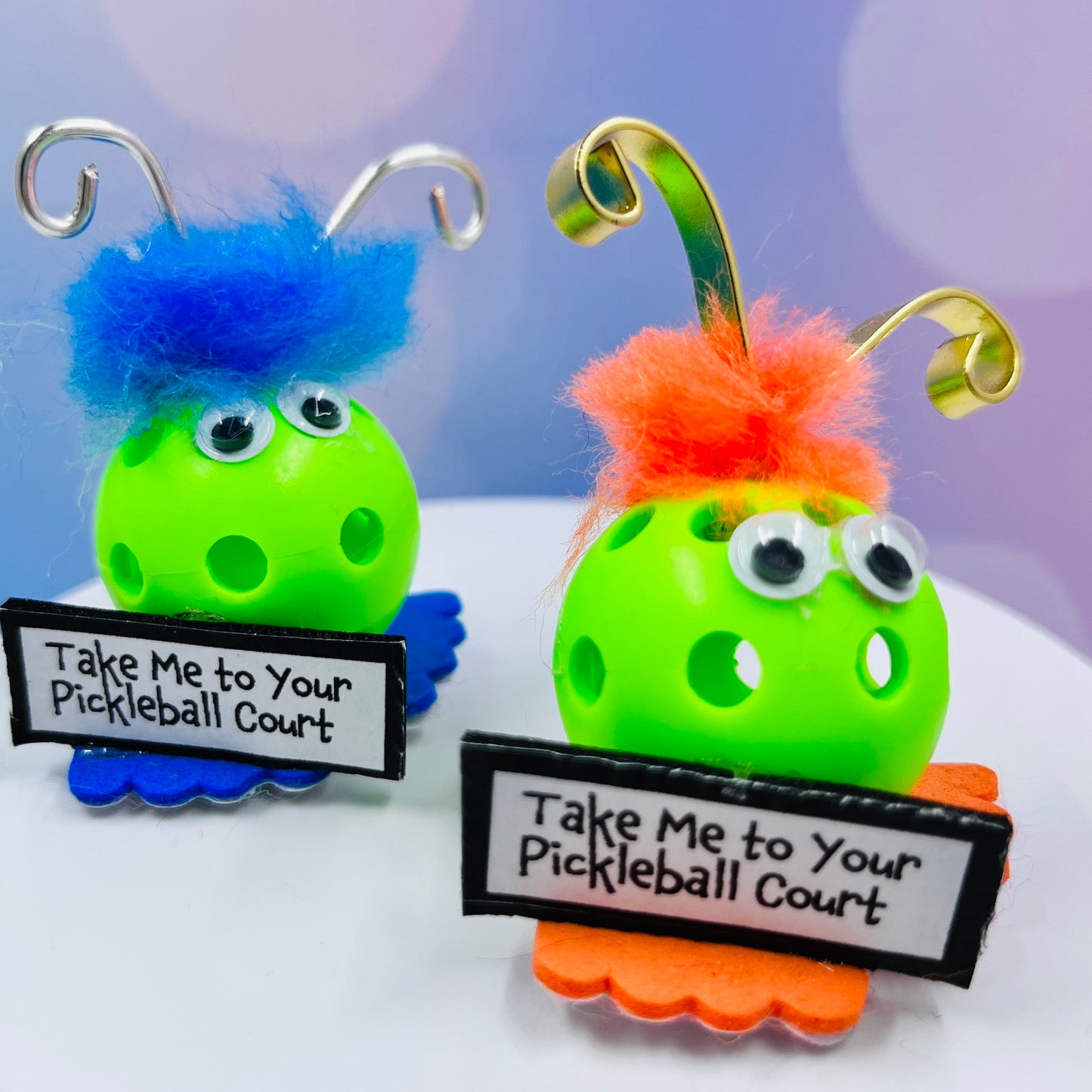 Alien Pickleball Cake Toppers and Decorations  Party like only pickleballers can! These fun decorations are the perfect additional to your pickleball celebration. Give them as a gift or attach them to a gift to delight your pickleball family. We ballers are always looking for a reason to party, so whether it is for a birthday, anniversary, celebration or just because it’s Tuesday, these accents will be the hit of the party. 