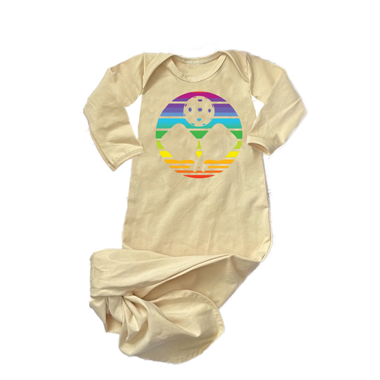 Pickleball Design: Infant Pickleball Rainbow  Newborn Baby Girl or Baby Boy Knotted Tie Gown  Celebrate the baby coming home along with your love of pickleball. Choose from several fun designs that will make your little one the envy of the nursery. Show your love with these cute "Knotted Gowns" designed for the pickleball addict's newest addition to the family.