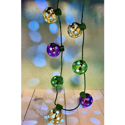Mini Pickleballs Mardi Gras Flashing Necklace with Lights  Perfect gift for you or someone you know who loves pickleball!! Super fun for all pickleball Christmas parties. You will be the hit of the party.  Comes with 7 mini pickleball lights. It has 3 functions including fast, slow, and steady.