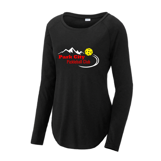 Pickleball Design: Park City Pickleball Club (red words)  Women's Style: Long Sleeve Scoop-Neck  Turn up the volume in this Women's shirt with its perfect mix of softness and attitude. Material is ultra-comfortable with moisture wicking properties and tri-blend softness. PosiCharge technology locks in color. Highly breathable and lightweight.