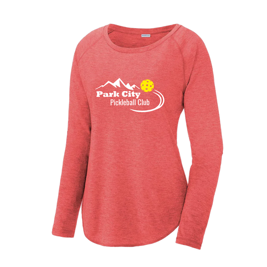 Pickleball Design: Park City Pickleball Club (white words)  Women's Style: Long Sleeve Scoop-Neck  Turn up the volume in this Women's shirt with its perfect mix of softness and attitude. Material is ultra-comfortable with moisture wicking properties and tri-blend softness. PosiCharge technology locks in color. Highly breathable and lightweight.