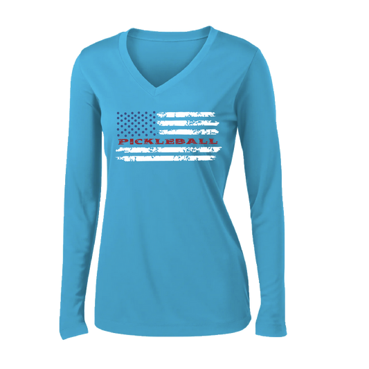 Pickleball Design: Flag Horizontal on Front or Back of Shirt  Women's Style: Long-Sleeve V-Neck  Turn up the volume in this Women's shirt with its perfect mix of softness and attitude. Material is ultra-comfortable with moisture wicking properties and tri-blend softness. PosiCharge technology locks in color. Highly breathable and lightweight.