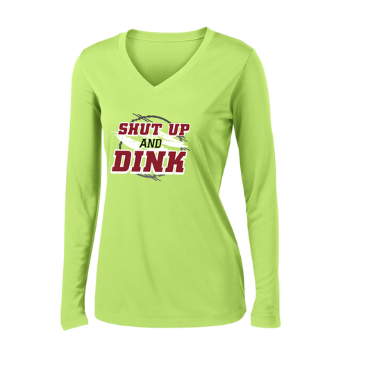 Pickleball Design: Shut up and Dink  Women's Styles: Long-Sleeve V-Neck  Turn up the volume in this Women's shirt with its perfect mix of softness and attitude. Material is ultra-comfortable with moisture wicking properties and tri-blend softness. PosiCharge technology locks in color. Highly breathable and lightweight.