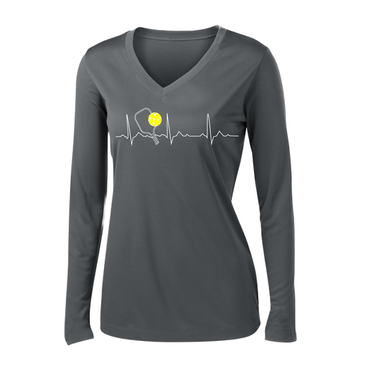 Pickleball Design: Heartbeat  Women's Style: Long Sleeve V-Neck  Turn up the volume in this Women's shirt with its perfect mix of softness and attitude. Material is ultra-comfortable with moisture wicking properties and tri-blend softness. PosiCharge technology locks in color. Highly breathable and lightweight.