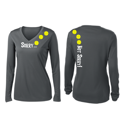 Pickleball Design: Sorry...Not Sorry with Customizable Ball Color – White, Yellow or Pink Balls Women's Styles: Long-Sleeve V-Neck Turn up the volume in this Women's shirt with its perfect mix of softness and attitude. Material is ultra-comfortable with moisture wicking properties and tri-blend softness. PosiCharge technology locks in color. Highly breathable and lightweight.