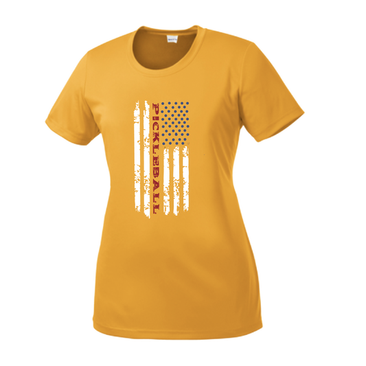 Pickleball Design: Flag Vertical on Front or Back of Shirt  Women's Style: Short-Sleeve Crew-Neck  Turn up the volume in this Women's shirt with its perfect mix of softness and attitude. Material is ultra-comfortable with moisture wicking properties and tri-blend softness. PosiCharge technology locks in color. Highly breathable and lightweight.