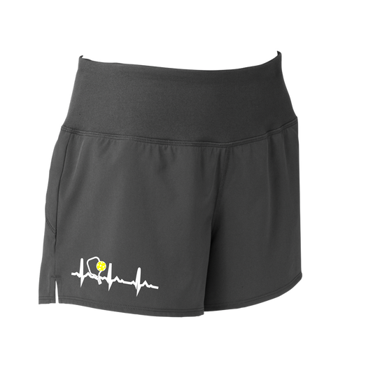 Pickleball Designs: Pickleball Heartbeat  Sport Tek women’s repeat shorts come with built-in cell phone pocket on the exterior of the waistband. You can also feel secure knowing that no matter how strenuous the exercise, the shorts will remain in place (it won’t ride up!). These shorts are extremely versatile and trendy. Transition from the Pickleball court to running errands smoothly.
