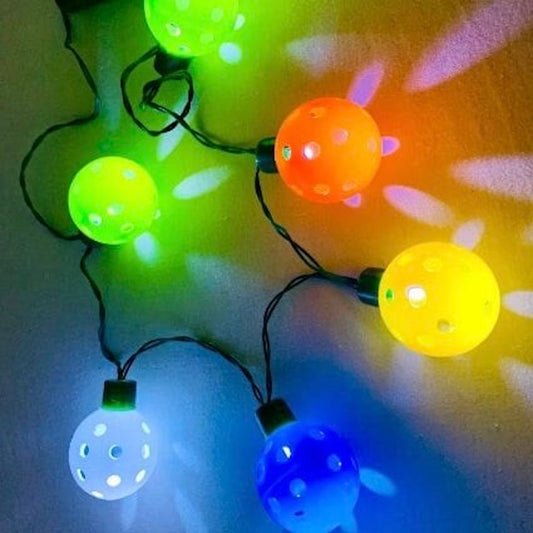 Mini Pickleball Flashing Necklace with LED Lights  Perfect gift for you or someone you know who loves pickleball!! Super fun for all pickleball Christmas parties. You will be the hit of the party.  Comes with 6 mini pickleball lights. It has 3 fun functions including fast, slow, and steady.