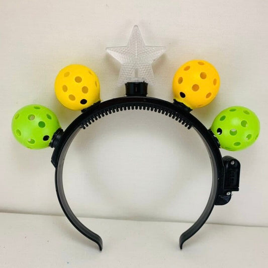 Mini Pickleball Headband with LED Lights  Perfect gift for you or someone you know who loves pickleball!! Super fun for all pickleball Christmas parties. You will be the hit of the party.  Comes with 4 Mini pickleballs and a star on top!!! It has 3 fun modes also.